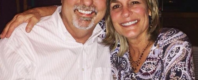 A man and woman posing for a photo at a restaurant.