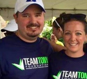 A man and woman wearing team town t - shirts.