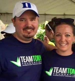 A man and woman wearing team town t - shirts.
