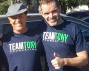 Three men posing with t - shirts that say team tony.